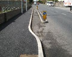 A finished roadside kerb edge with tarmac